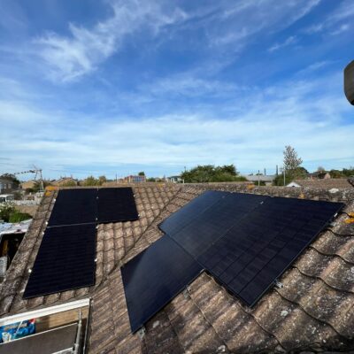 All black solar panels installed on a concrete roof